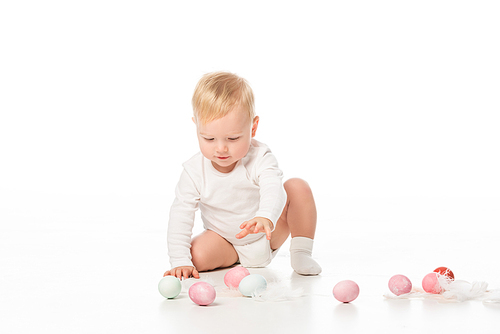 cute child outstretching hand to . eggs on white background