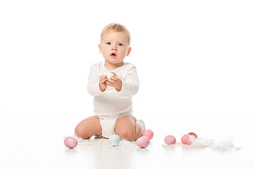 child with open mouth, holding . egg and  on white background