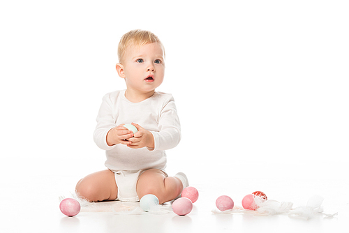 child with open mouth, holding . egg on white background