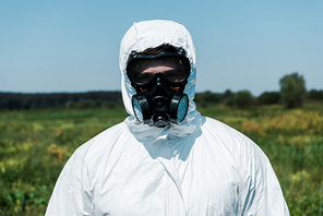 exterminator in protective white uniform standing outside