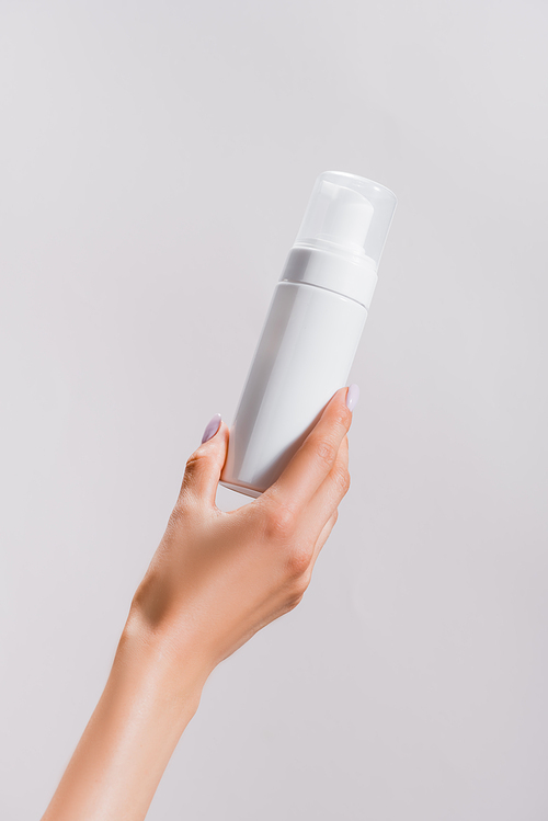 cropped view of woman holding cleansing foam isolated on grey