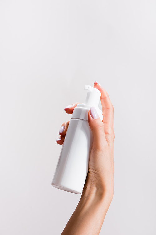 cropped view of woman holding cleansing foam isolated on grey