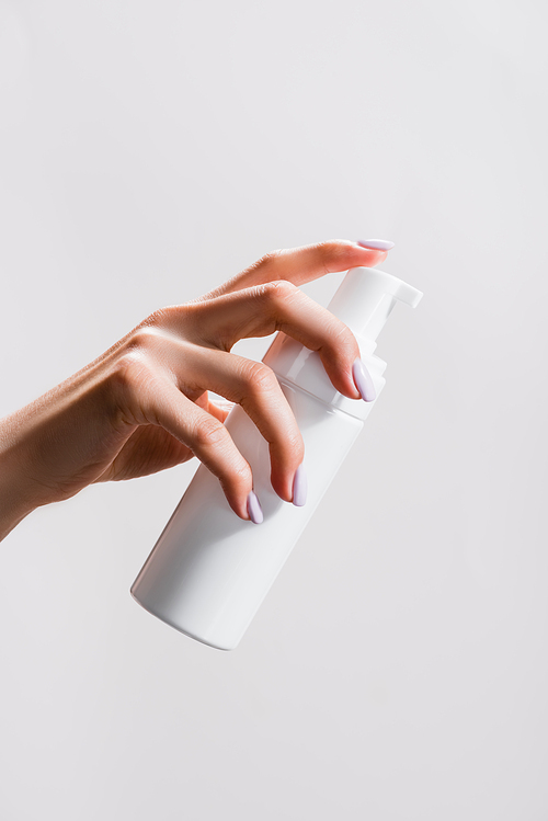 cropped view of woman holding cleansing foam isolated on grey