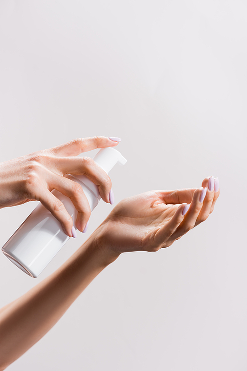 cropped view of woman applying cleansing foam isolated on grey