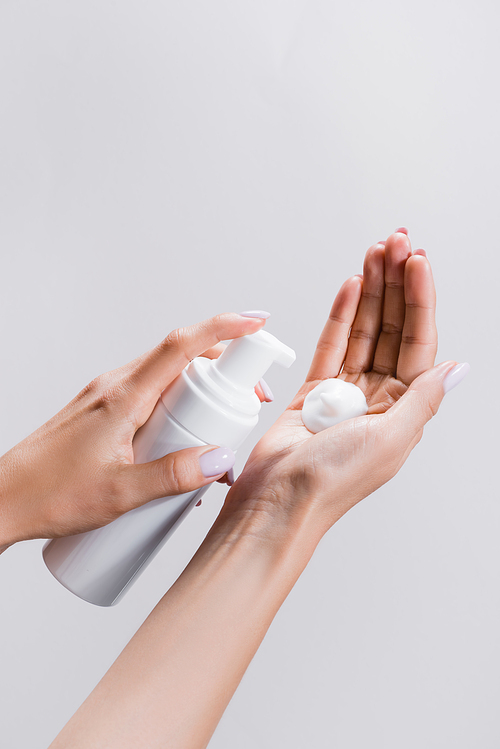 cropped view of woman applying cleansing foam isolated on grey