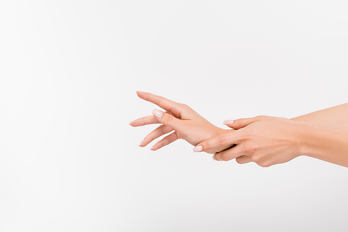 cropped view of woman applying hand cream isolated on white