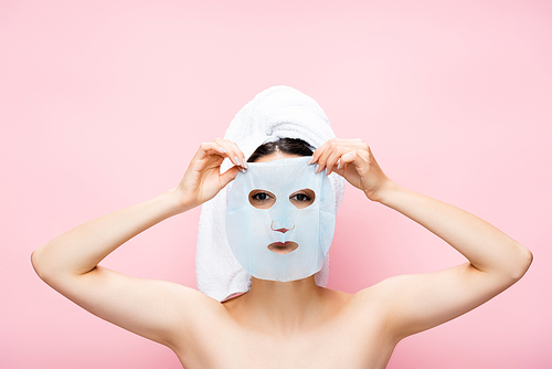 beautiful woman with mask sheet on face isolated on pink