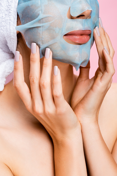 cropped view of beautiful woman with mask sheet on face isolated on pink