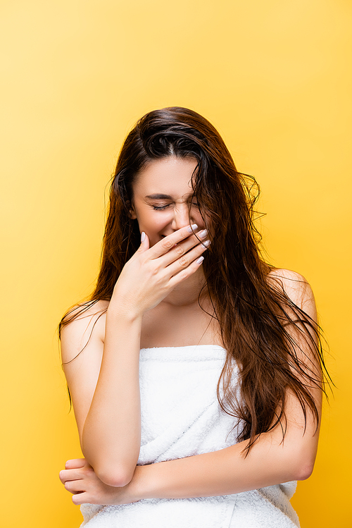 laughing beautiful woman with wet hair isolated on yellow