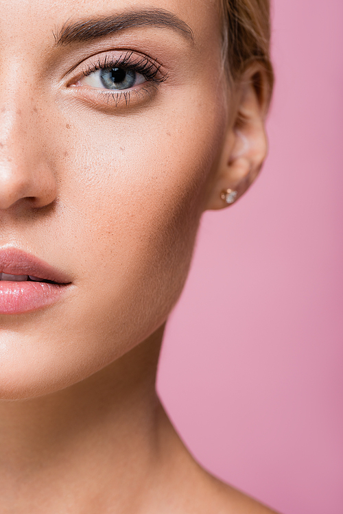 cropped view of beautiful woman with freckles isolated on pink