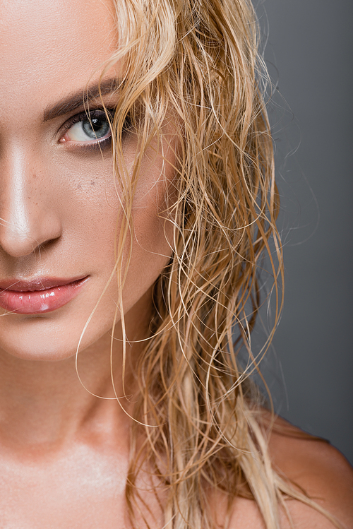 blonde woman with wet hair isolated on grey