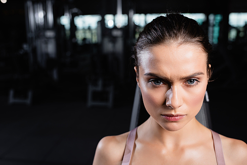 portrait of confident, young sportswoman in sports center