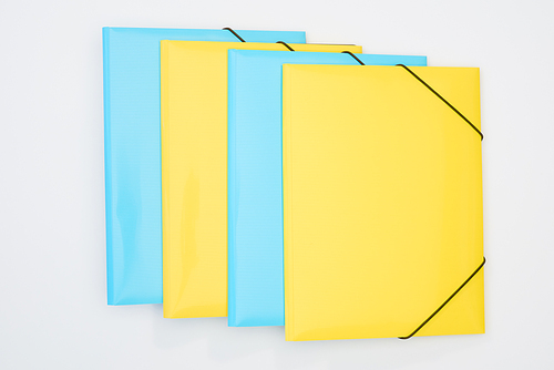 flat lay of yellow and blue folders isolated on white
