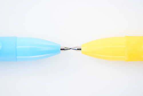 close up view of yellow and blue pencils isolated on white