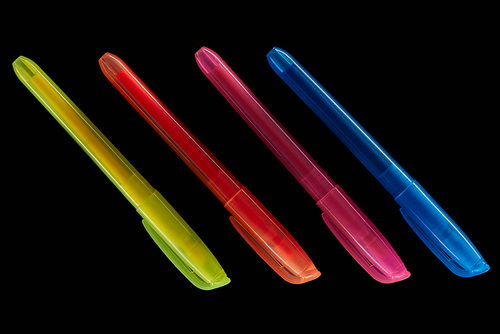 top view of yellow, red, blue and pink markers isolated on black