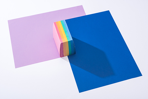 high angle view of colorful papers and sticky notes on white background