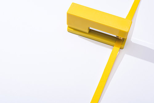 high angle view of stapler and paper strip on white background