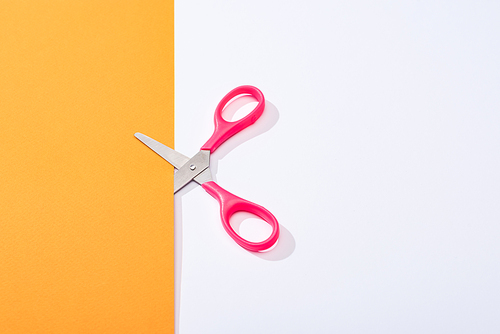 top view of scissors and colorful paper on white background