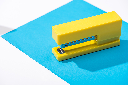 high angle view of stapler and paper on white background