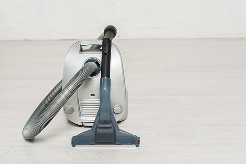 modern vacuum cleaner with handle on floor