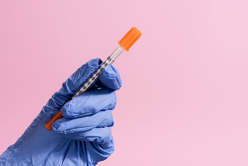 cropped view of hand in latex glove with vaccine isolated on pink