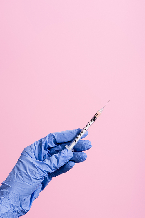 cropped view of hand in blue latex glove with syringe isolated on pink