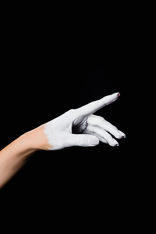 partial view of white painted hand isolated on black