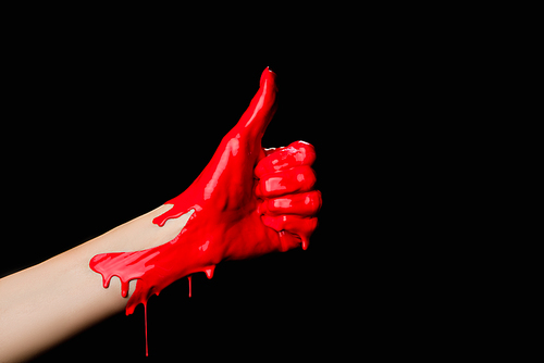 cropped view of hand painted in red paint showing thumb up isolated on black