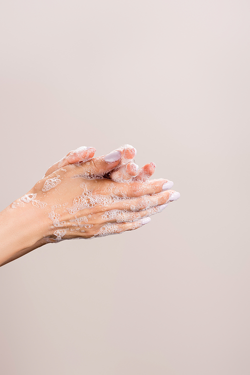 cropped view of woman washing hands isolated on grey