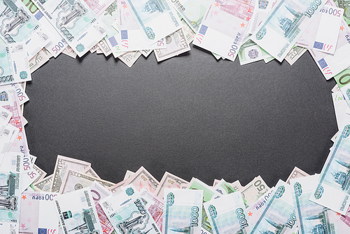 top view of empty frame of dollar, euro and ruble banknotes on black background with copy space