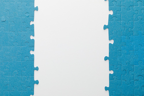 top view of blue jigsaw puzzle on white background
