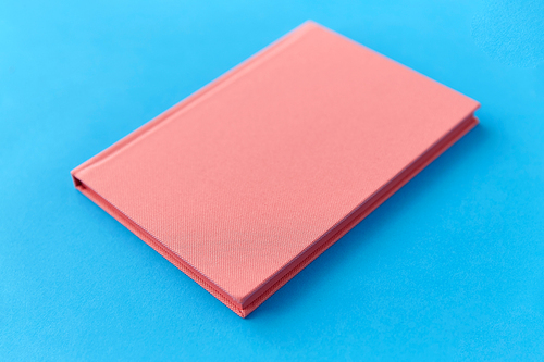 education and object concept - notebook or diary on blue background