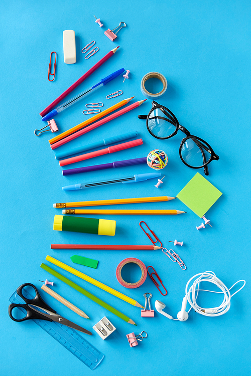 education, office and object concept - stationery or school supplies on blue background