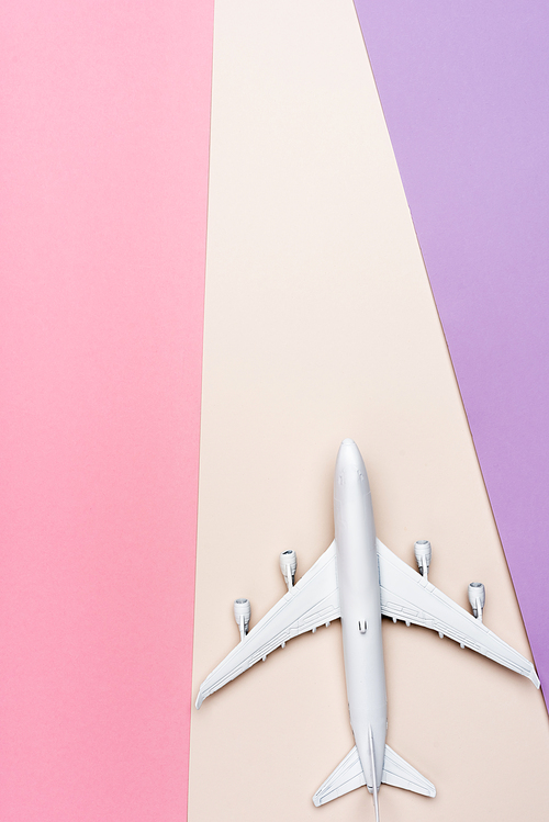 top view of white plane model on colorful background