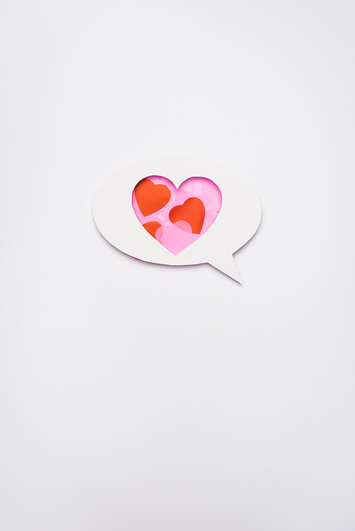top view of speech bubble with hearts on white background