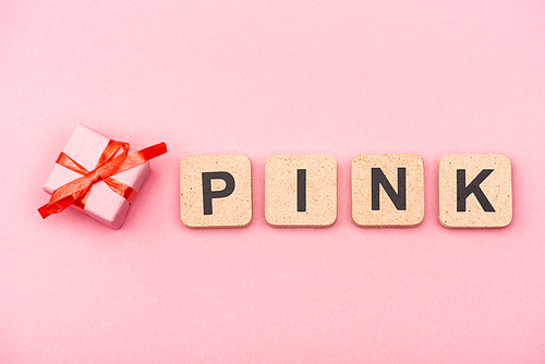 top view of word pink on cubes and gift box