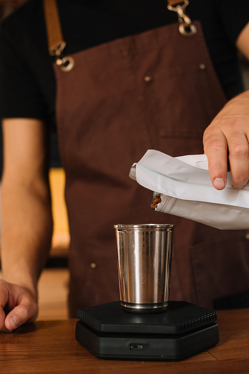 partial view of barista preparing coffee