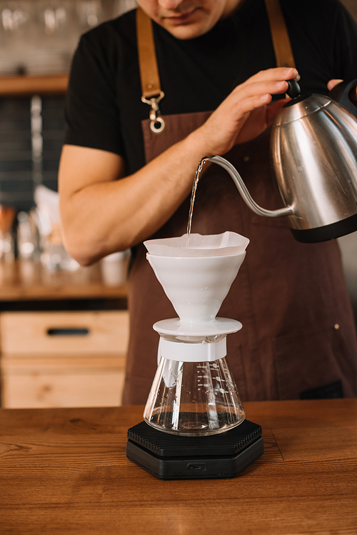 cropped view of barista preparing filtered coffee