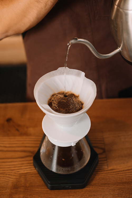 cropped view of barista preparing filtered coffee