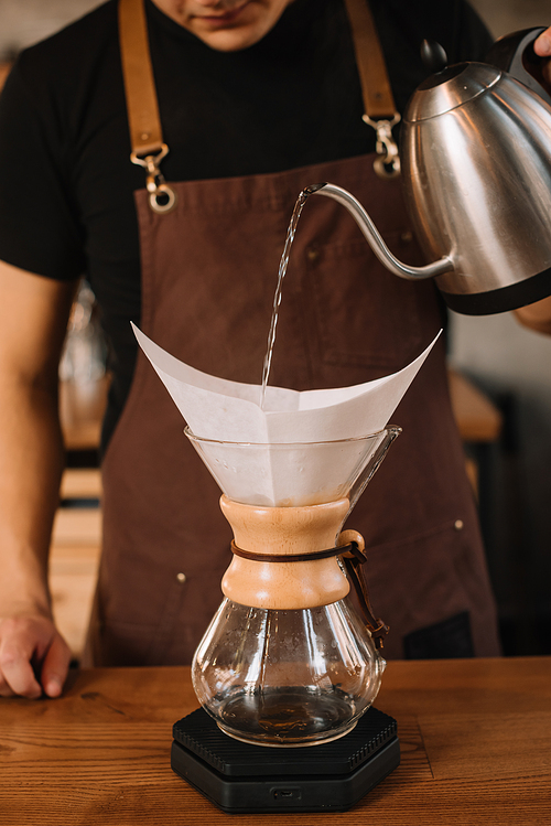 cropped view of barista preparing filtered coffee