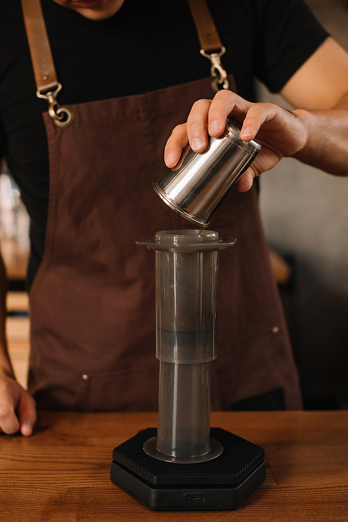 cropped view of barista preparing brewed coffee with aeropress