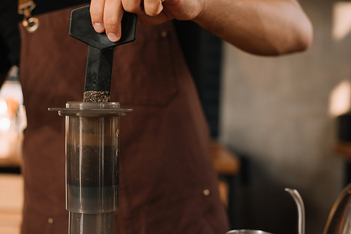 cropped view of barista preparing coffee with aeropress