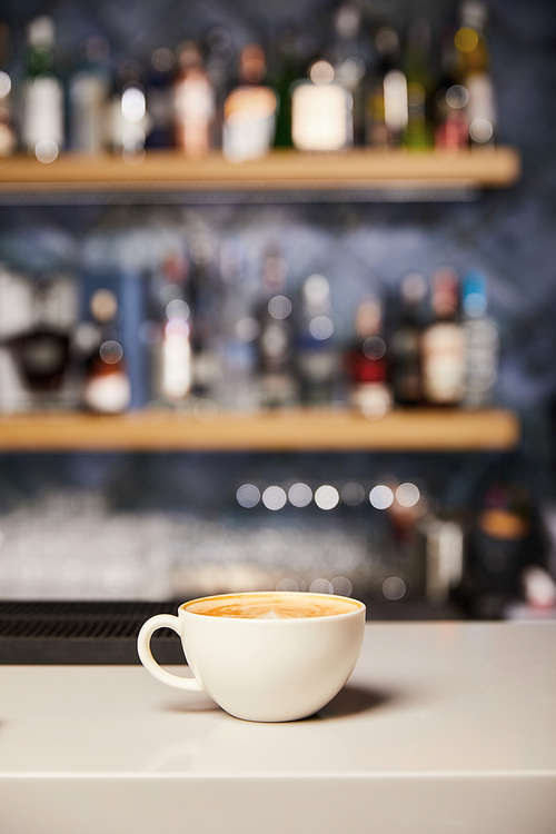 selective focus of hot and tasty cappuccino in white cup