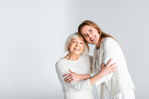 senior mother hugging with happy daughter isolated on grey