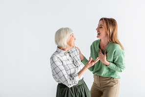 generation of happy women laughing while looking at each other isolated on white