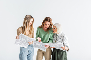 three generation of women reading newspapers isolated on white