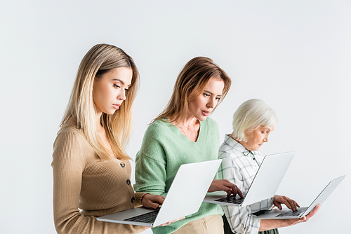 three generation of women using laptops isolated on white