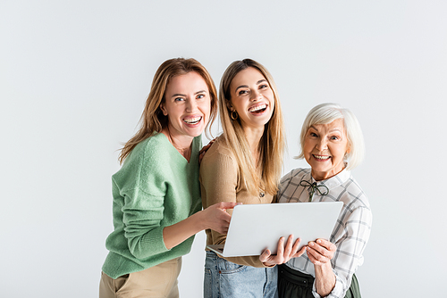 three generation of happy women  near laptop isolated on white