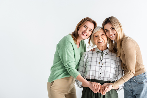 three generation of happy women  and holding hands isolated on white
