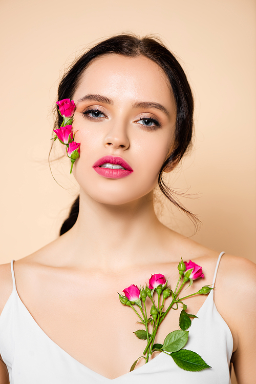 sensual young woman  near flowers isolated on pink